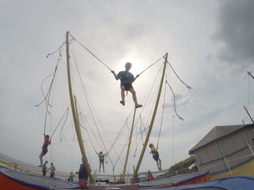 Children having fun on bungee trampoline
